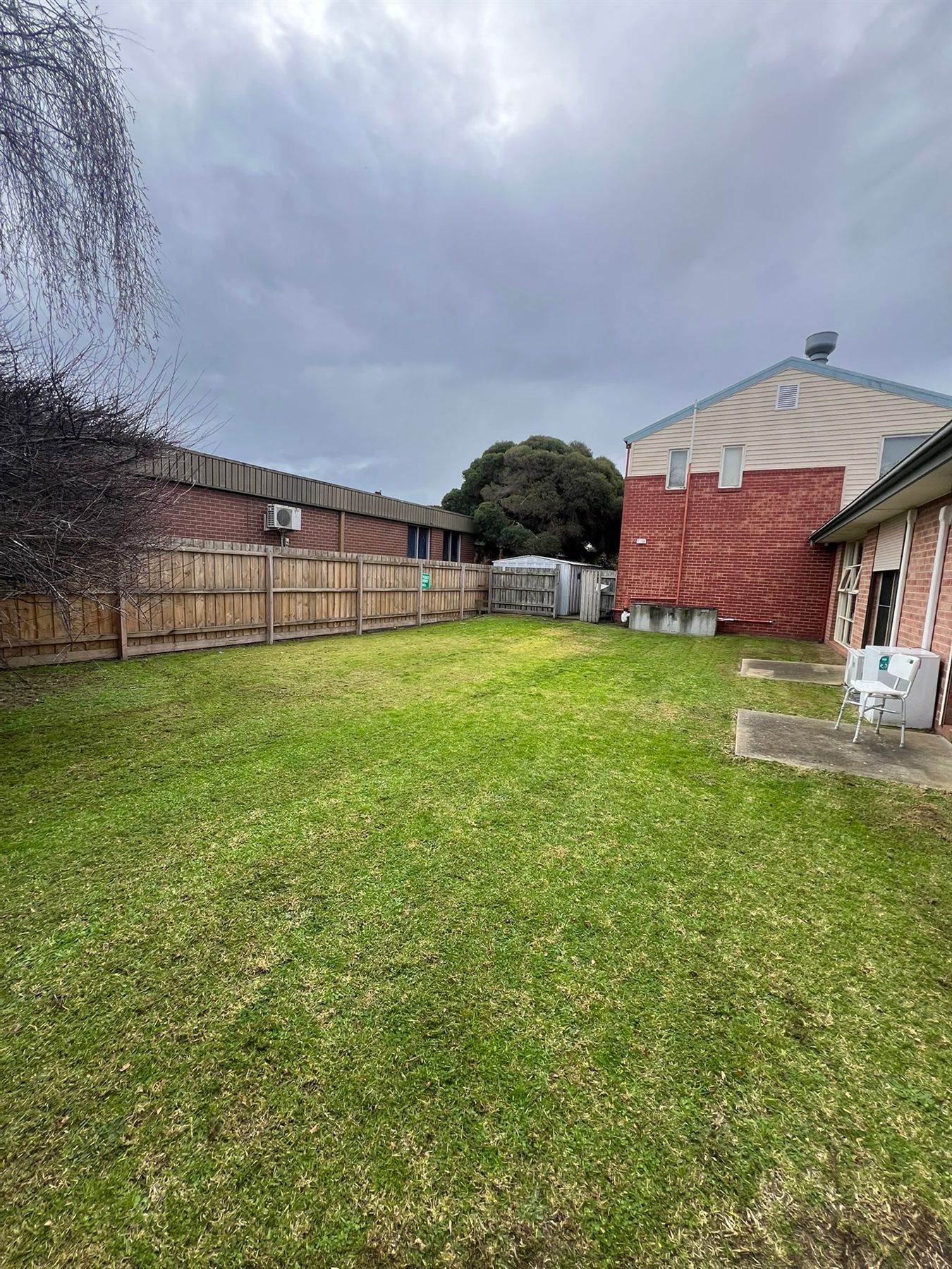 Maintained backyard lawn beside residential buildings